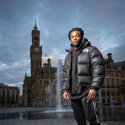 A student posing in City Square in the Bradford City Centre