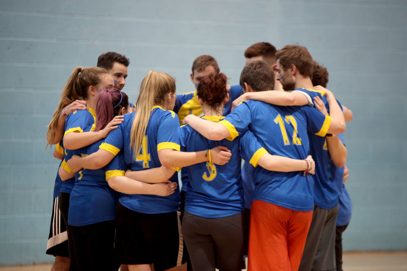 Sports team in a group huddle