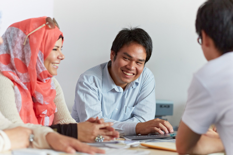 International students chatting to each other at a table