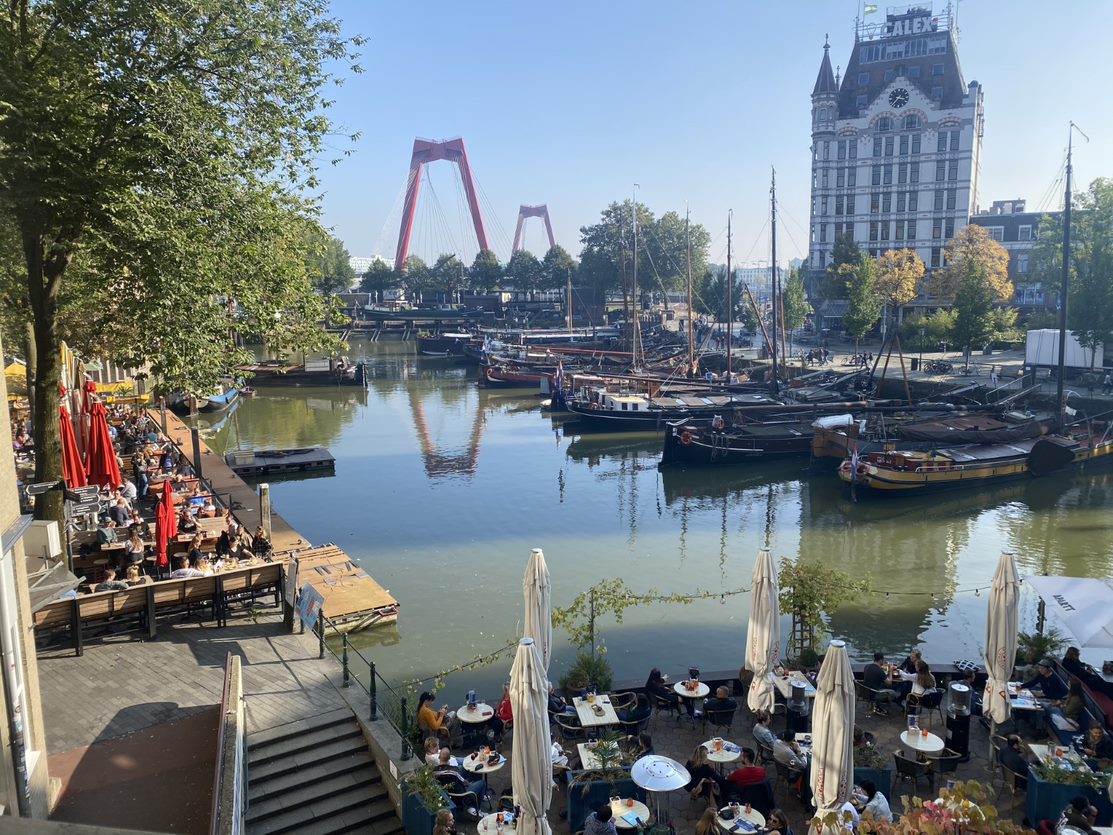 The city of Leiden, showing a canal, boats and a red bridge