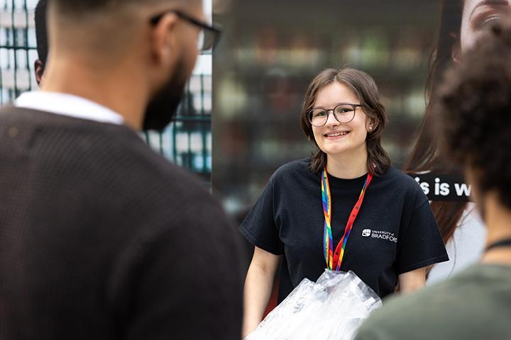 A Bradford student ambassador smiling at event attendees