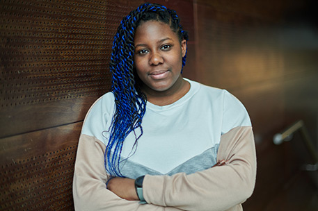 Headshot of University of Bradford student Esther Aroyehun stood with her arms folded.