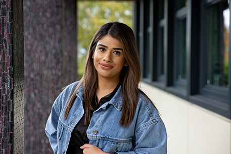 Student wearing a jacket smiling