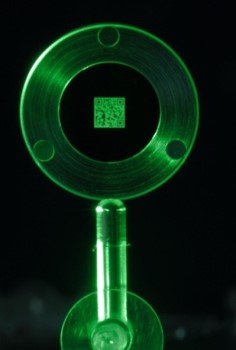 QR code visible in the darkness under a green light.