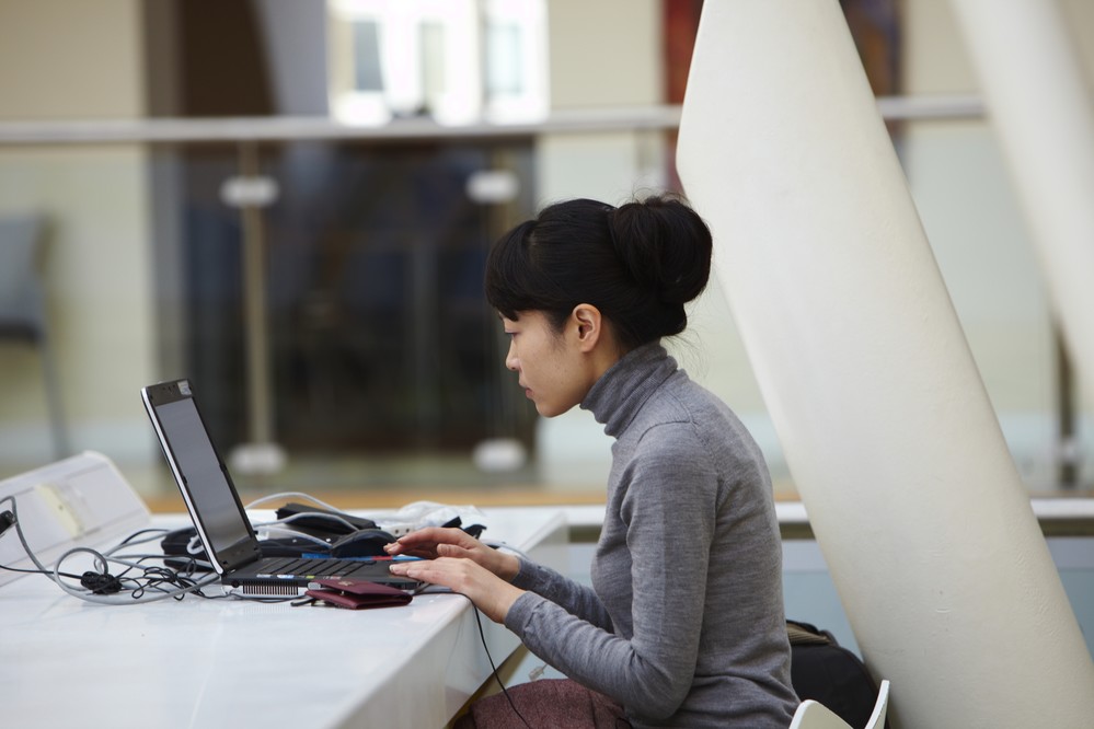 A student working on a laptop.