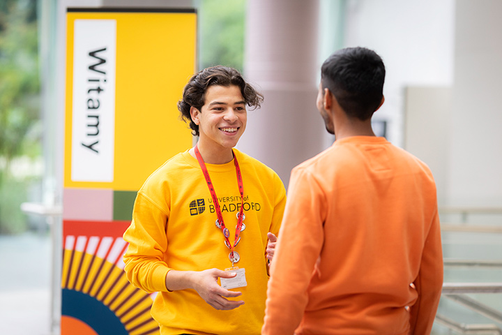 A student chatting to a student ambassador in the Atrium