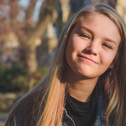 A square image taken by Bradford student Faith, of her blonde female friend smiling at the camera