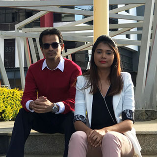 Shabeel and Farzanah sitting together outside in a park.