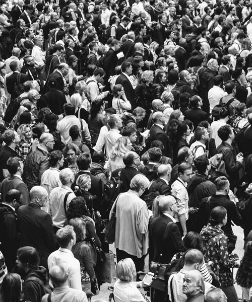 Photo of a crown of people together paying attention to something ahead.