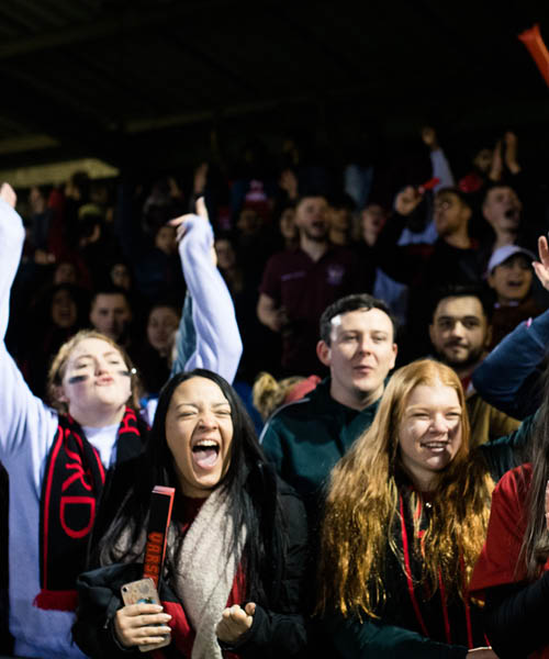 Crowd cheering University of Bradford at Varsity sporting event.