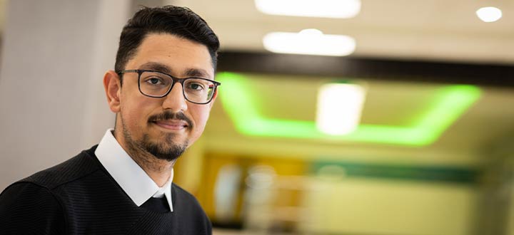 Billal, an optometry student, smiling at the camera.