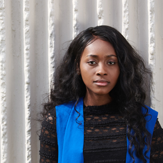 Poshia, Clinical Sciences student, smiling at the camera.